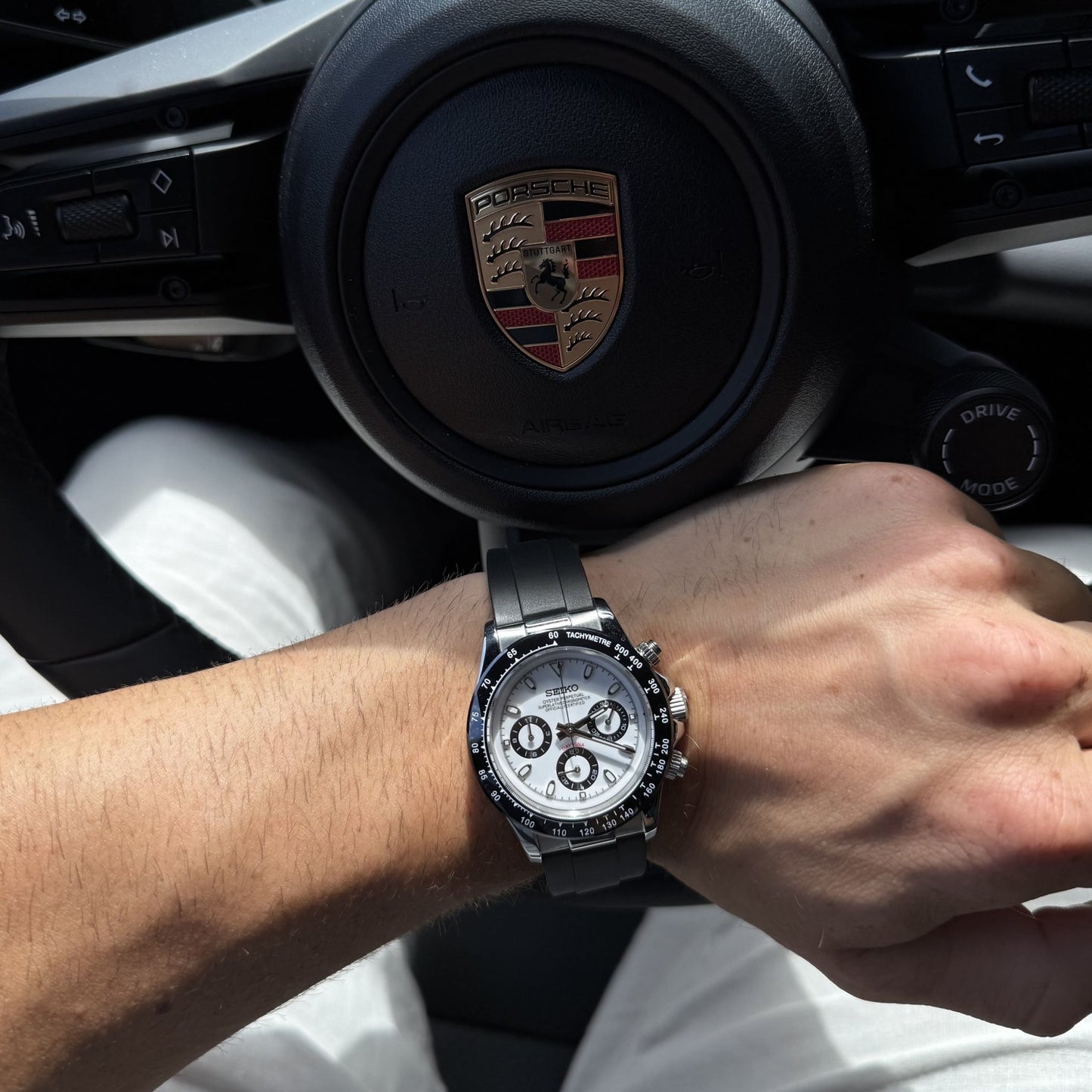 SeikoMod Daytona Panda 41mm am Handgelenk, am Lenkrad eines Sportwagens getragen