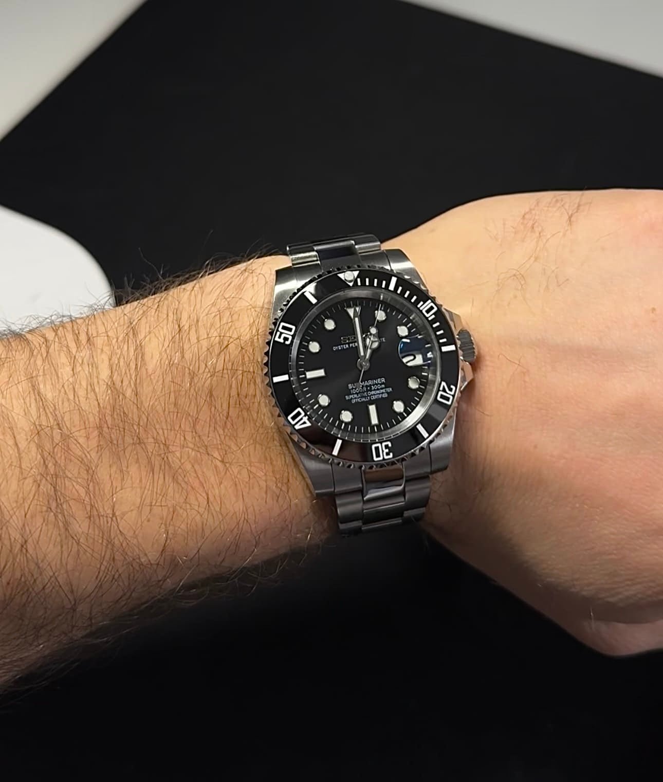 The SeikoMod Submariner Black being worn on a wrist.
